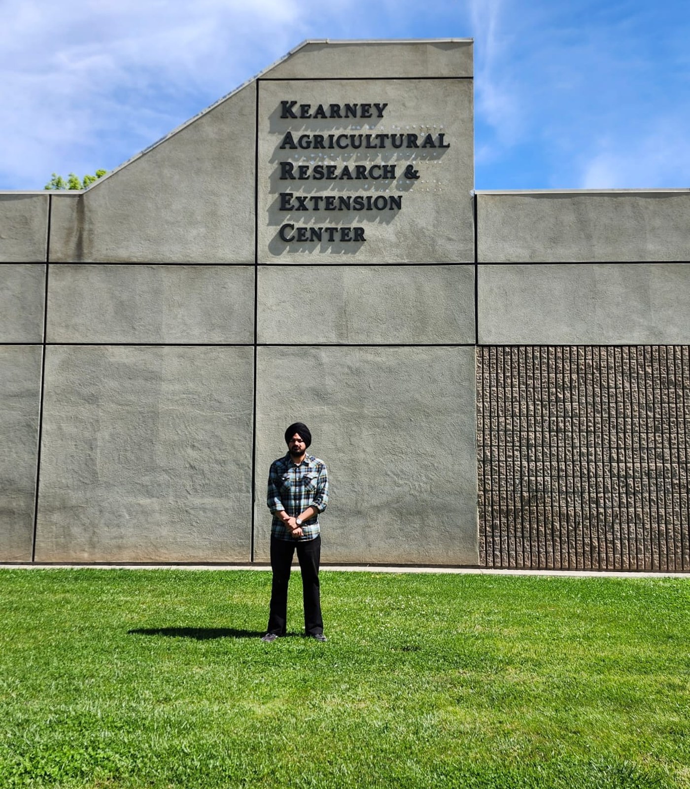 Sunnyrudh Singh standing outside an academic building at California State University, Fresno